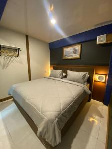 a bedroom with a large white bed in a room at Pondanu Cabins By The Lake in Bedugul