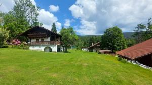 a house in the middle of a green field at Pension Klose in Kubova Huť