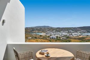 a room with a table and a view of a city at Due Mari Mykonos in Agios Ioannis Mykonos