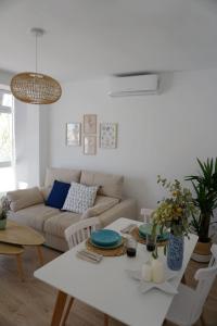 a living room with a white table and a couch at Casa Keko in La Herradura