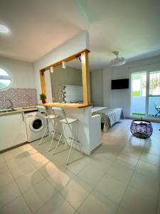a kitchen with a washing machine and a table at MyChoice Alegria in Rota