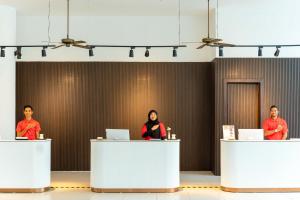 a group of people standing at tables in a room at Wings by Croske Resort Langkawi in Pantai Cenang