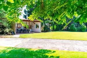 a house with a garden and a lawn with a sidewalk at Villa Bougainvillea in Órmos