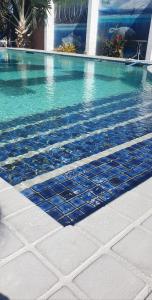 a swimming pool with blue water in a building at Burdekin Motor Inn in Home Hill