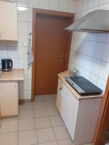 a small kitchen with a stove and a sink at U Gacka in Władysławowo