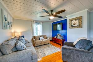 a living room with two couches and a ceiling fan at Dobson Farmhouse with Scenic Porch - Near Vineyards! in Dobson