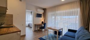a living room with a blue couch and a table at Amber Drop apartments in Palanga