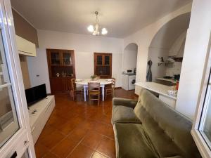 a living room with a couch and a table at Casa LELLA in Rocca di Papa +12 photos