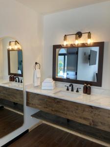 a bathroom with two sinks and a large mirror at Hotel Frisco in Frisco