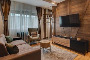 a living room with a couch and a flat screen tv at MODERN MOUNTAIN II in Kolašin
