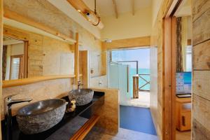 two sinks in a bathroom with a view of the ocean at You & Me Maldives - Adults Only - Premium All-Inclusive in Raa Atoll