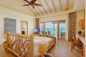 a bedroom with a bed with a view of the ocean at You & Me Maldives - Adults Only - Premium All-Inclusive in Raa Atoll