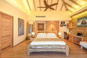 a bedroom with a bed and a ceiling fan at You & Me Maldives - Adults Only - Premium All-Inclusive in Raa Atoll