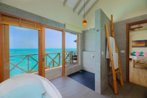 a bathroom with a tub and a view of the ocean at You & Me Maldives - Adults Only - Premium All-Inclusive in Raa Atoll