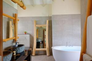 a bathroom with a bath tub and a sink at You & Me Maldives - Adults Only - Premium All-Inclusive in Raa Atoll