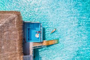 two people on a boat in the water at You & Me Maldives - Adults Only - Premium All-Inclusive in Raa Atoll
