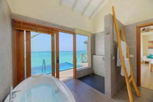 a bathroom with a tub and a view of the ocean at You & Me Maldives - Adults Only - Premium All-Inclusive in Raa Atoll