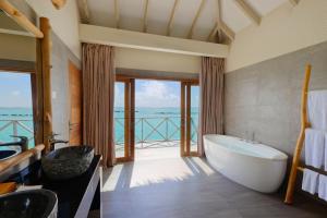 a bathroom with a tub and a view of the ocean at You & Me Maldives - Adults Only - Premium All-Inclusive in Raa Atoll