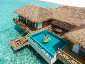 an aerial view of a resort in the water at You & Me Maldives - Adults Only - Premium All-Inclusive in Raa Atoll