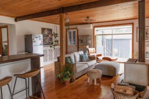a kitchen and living room with a couch and a refrigerator at Happy Nomad in St Helens