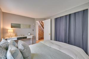 a bedroom with a white bed and a window at Cozy Boston Vacation Rental with Rooftop Deck! in Boston