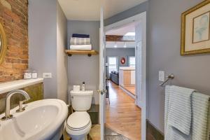 a bathroom with a white toilet and a sink at Cozy Boston Vacation Rental with Rooftop Deck! in Boston