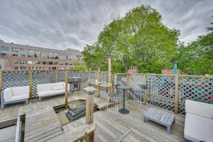 a deck with a table and chairs on a balcony at Cozy Boston Vacation Rental with Rooftop Deck! in Boston