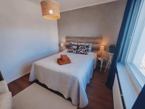 a bedroom with a bed with a purse on it at Private apartment near Ruissalo, Castle, Harbour - AC, Free parking in Turku