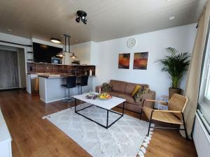 a living room with a couch and a table at Private apartment near Ruissalo, Castle, Harbour - AC, Free parking in Turku