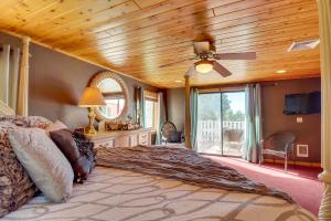 a bedroom with a large bed with a wooden ceiling at Near Sitgreaves Natl Park High Country Farmhouse in Overgaard