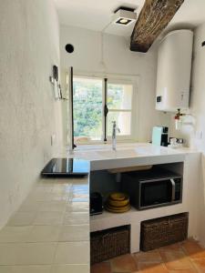 a kitchen with a sink and a microwave at Cosy and Comfy Studio with Sea View in Tourrettes-sur-Loup +31 photos
