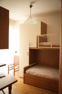 een slaapkamer met een stapelbed en een tafel bij Sole&Luna Apartment in Trento