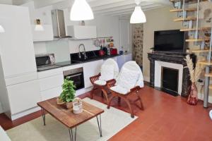 a living room with two chairs and a table at Charmant duplex en centre-ville in Le Mans