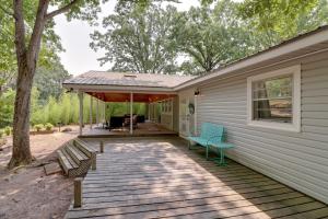 a deck with two chairs and a house at Arkansas Vacation Rental on Greers Ferry Lake! in Fairfield Bay