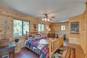 a bedroom with a bed and a ceiling fan at Charming Cabin Near Kirkwood Ski Resort with Hot Tub in Pioneer