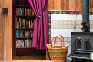 a book shelf filled with books next to a fireplace at Hamakua Sanctuary in Honokaa