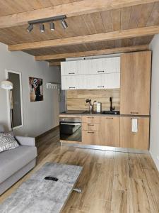 a living room with a couch and a kitchen at Moda Apartments 69 in Sestriere