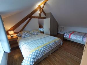 a bedroom with two beds in a attic at La Maison Normandelys in Les Andelys
