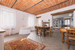 ein großes Wohnzimmer mit einem Tisch und Stühlen in der Unterkunft Lanterna delle Fate House and swimming pool for exclusive use in Asti