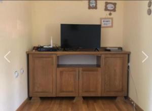a wooden entertainment center with a flat screen tv at Apartment Žugić in Žabljak