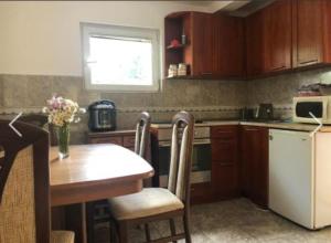 a kitchen with a table and a white refrigerator at Apartment Žugić in Žabljak
