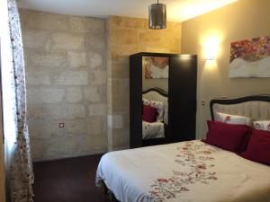 a bedroom with a bed and a large mirror at Appartements Bordeaux Saint Michel in Bordeaux