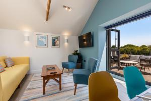 a living room with a couch and chairs and a table at Waterside Apartment in Paignton