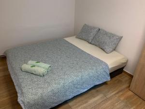 a small bed with two pillows on top of it at Apartmány na Vršku in Pilsen