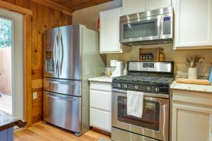 a kitchen with a stainless steel refrigerator and microwave at Twain Harte Cabin with Deck and Fire Pit! in Twain Harte