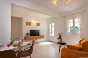 a living room with a table and a television at Apartments Laurea in Slano