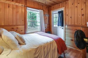 a bedroom with a bed and a window at Twain Harte Cabin with Deck and Fire Pit! in Twain Harte