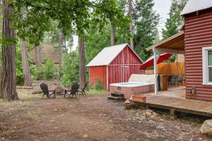a red house with a deck and a red barn at Twain Harte Cabin with Deck and Fire Pit! in Twain Harte