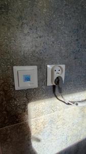 a electrical outlet on the wall of a bathroom at Nad Kalwą in Pasym
