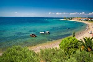 two boats in the water on a beach at Maistrali Beach Studios in Gerakini